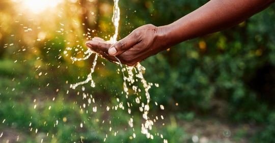 pure water pouring into someone's hand